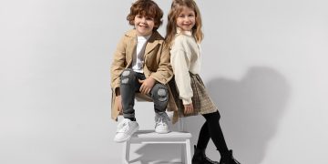 Fashion concept. Stylish children posing on light grey backgroun