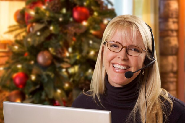 A customer service representative wearing a headset and smiling while assisting a Shein VIP member via live chat on a laptop. The background is a clean, modern office setting.
