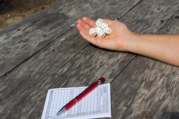 A close-up shot of a hand holding a pencil, filling out a multiple-choice question on a standardized test. The test sheet is slightly blurred in the background.