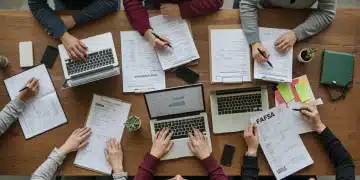 Students completing 2025 FAFSA applications on laptops, surrounded by financial aid documents