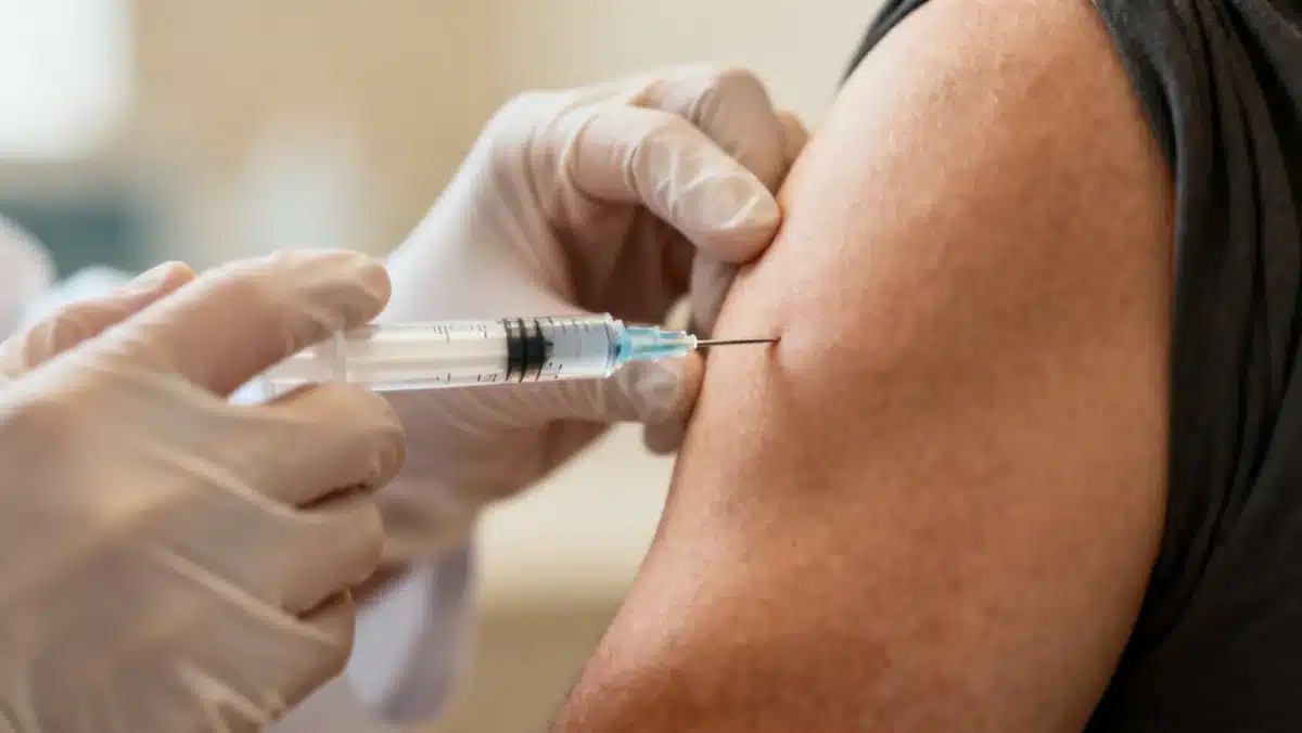 Healthcare professional administering a flu vaccine, highlighting the importance of early immunization.